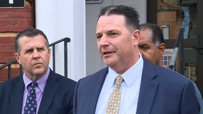 Brockton Public Schools Superintendent Michael Thomas speaks with members of the media during a news conference outside of the city's Therapeutic Day School in Brockton, Massachusetts on March 16, 2023. Brockton Mayor Robert Sullivan (left) listens in.