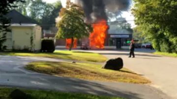 Firefighter injured as flames tear through commercial building