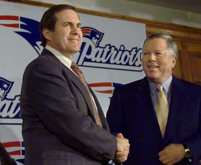 Newly-hired New England Patriots' head coach Bill Belichick, left, shakes hands with Patriots' owner Robert Kraft, seconds before the start of a news conference at Foxboro Stadium in Foxboro, Mass., held to announce Belichick's hiring Thursday, Jan. 27, 2000.