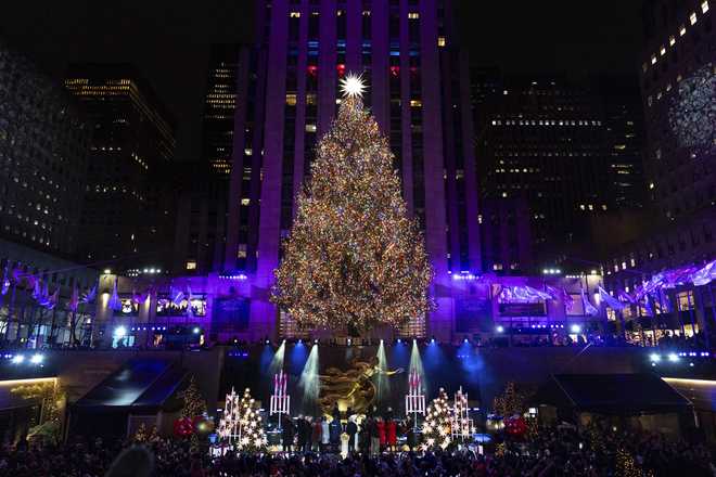 The Rockefeller Center Christmas tree is lit during the 92nd annual Rockefeller Center Christmas tree lighting ceremony, Wednesday, Dec. 4, 2024, in New York. (AP Photo/Julia Demaree Nikhinson)