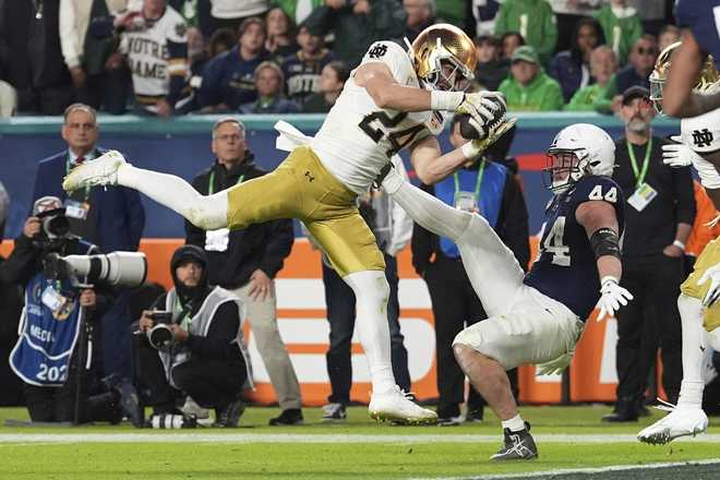 Notre Dame linebacker Jack Kiser (24) grabs a pass in front of Penn State tight end Tyler Warren (44) during the second half of the Orange Bowl College Football Playoff semifinal game, Thursday, Jan. 9, 2025, in Miami Gardens, Fla.