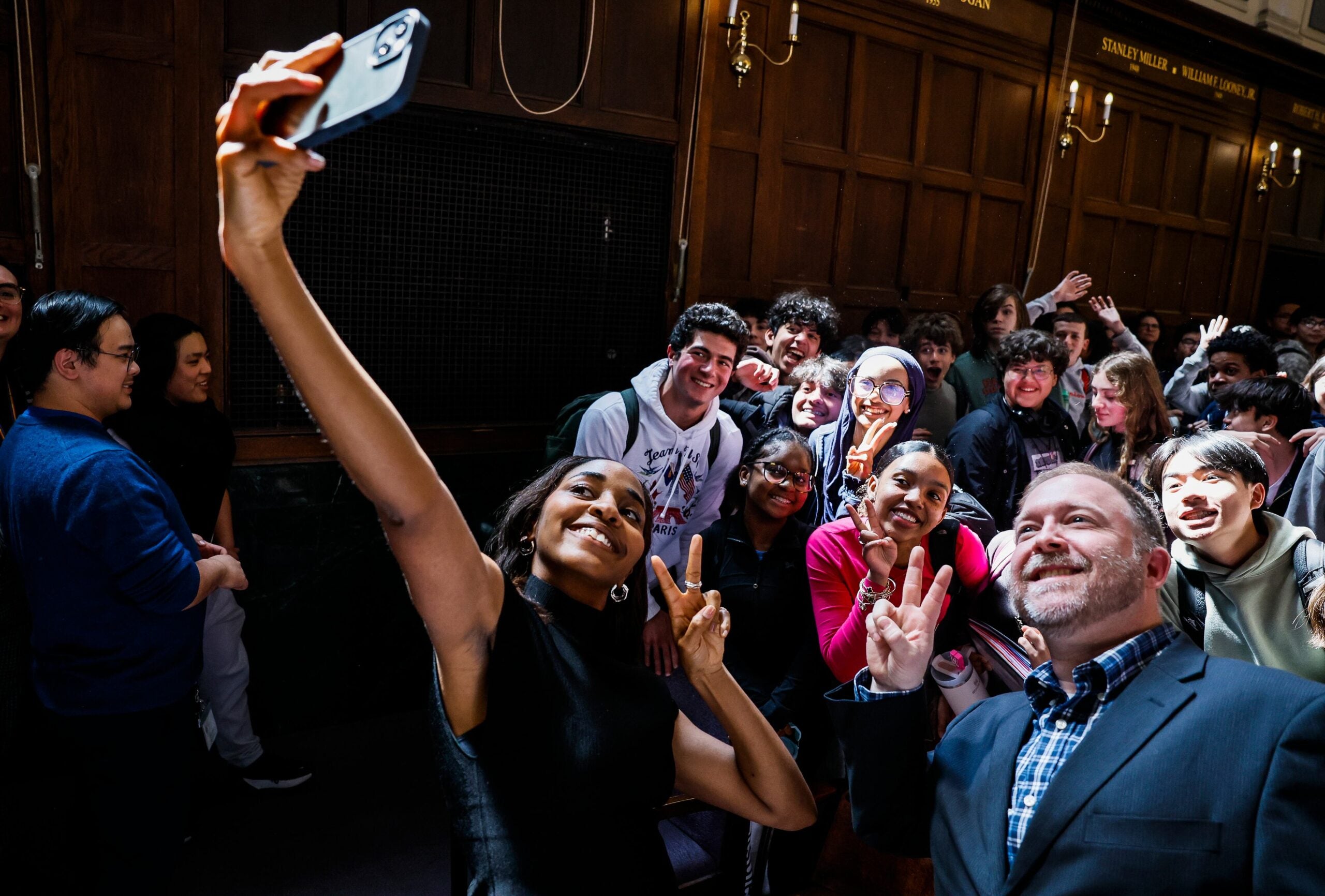 Emmy-winning actor Ayo Edebiri takes a selfie with Boston Latin School students and choir teacher Ryan Snyder, who was her acapella group instructor during her time at the school. Edebiri returned to her alma mater to speak with students about her journey from Boston Public Schools to a successful career in entertainment.