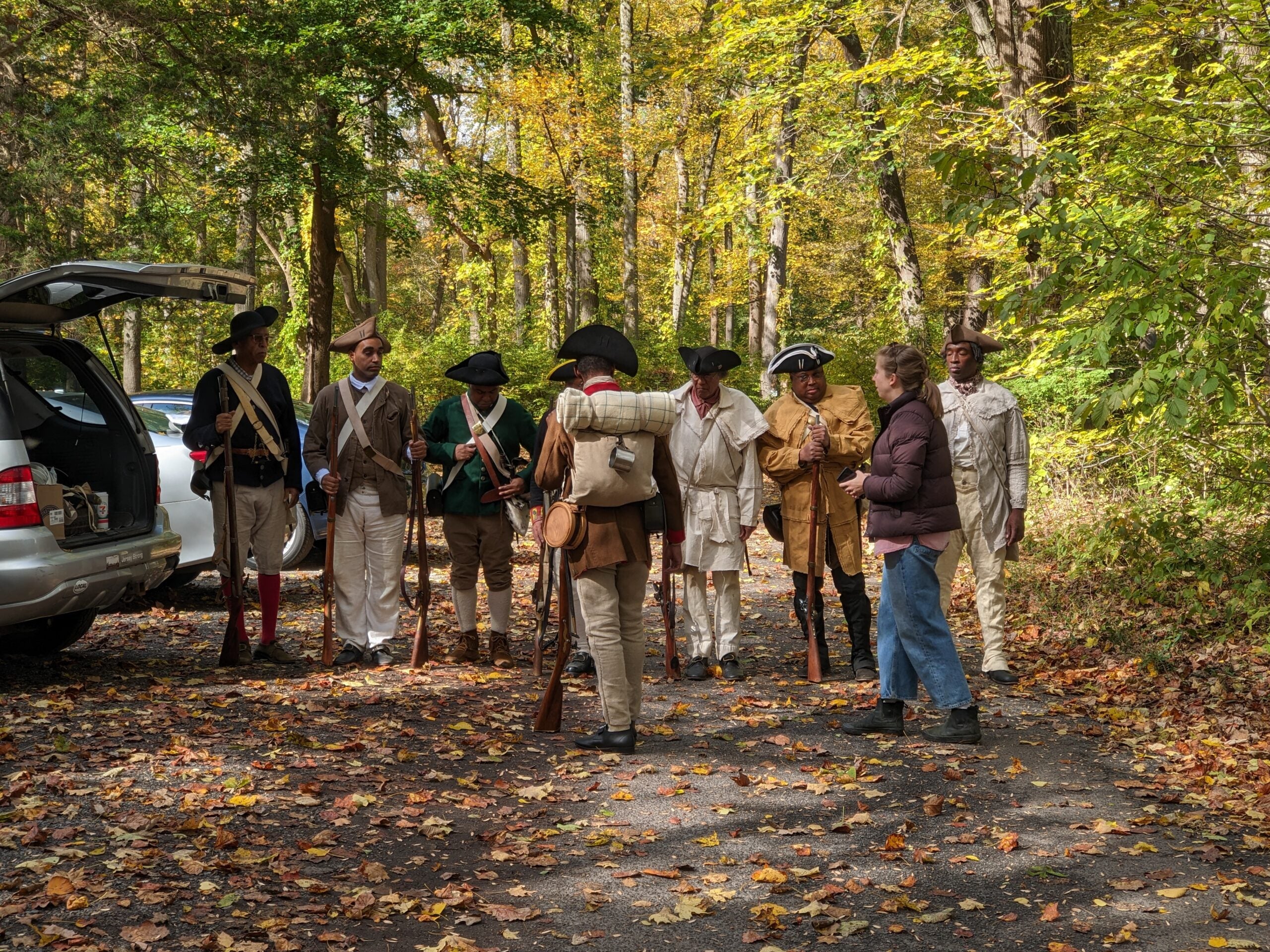 Co-producer Megan Ruffe speaks with reenactors from the 1st Rhode Island Regiment. 