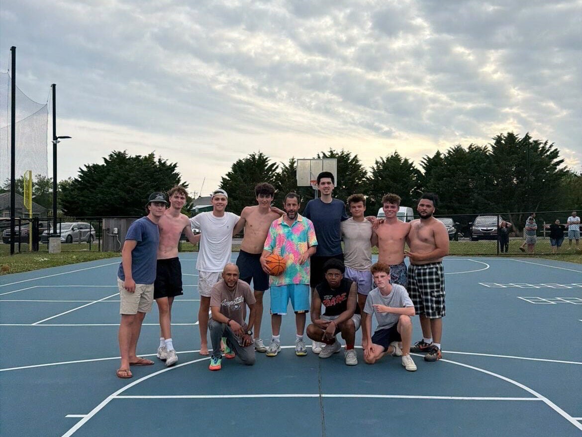 Adam Sandler poses with a group of pickup basketball players on Nantucket on Sunday, July 5.